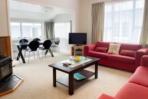 Vacation home living area with couches and large dining tables